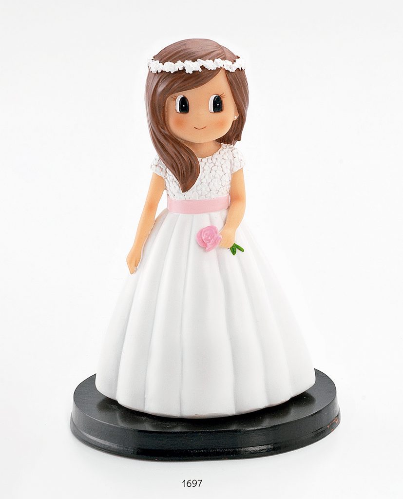 Figura de tarta de niña de comunión con flor y corona en el pelo.